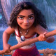 Moana holds an ore on a boat in the water